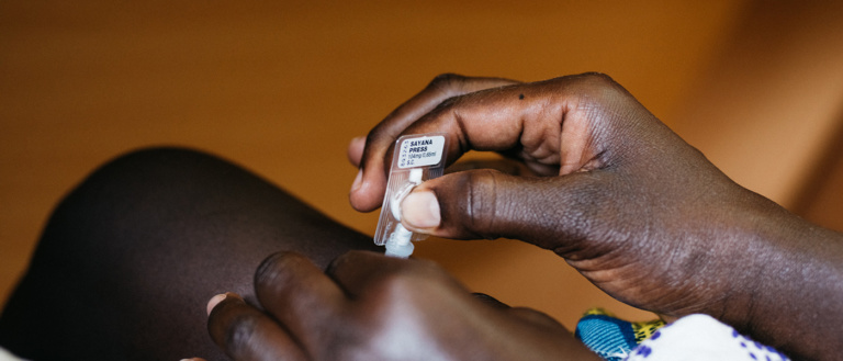 A woman injects herself with subcutaneous DMPA