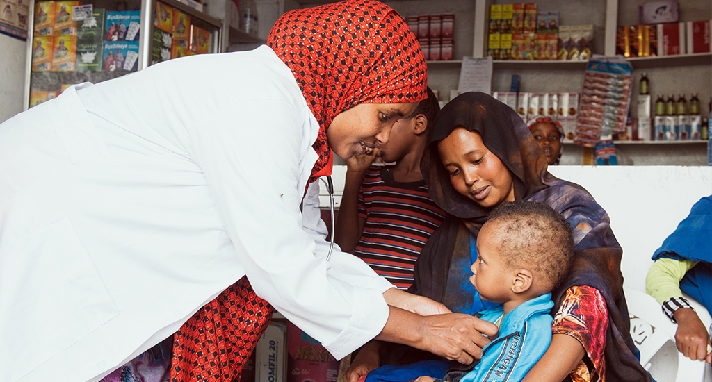Bulsho Kaab nurse, a member of PSI’s social franchise network, checks an infant patient in her pharmacy in Hargeisa, Somaliland.